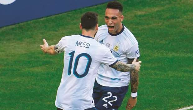 Argentinau2019s Lautaro Martinez (right) celebrates with captain Lionel Messi after scoring against Venezuela during the Copa America quarter-finals at Maracana Stadium in Rio de Janeiro, Brazil, on Friday night. (AFP)