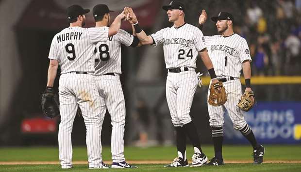 From left: Colorado Rockiesu2019 Daniel Murphy, Nolan Arenado, Ryan McMahon and Garrett Hampson celebrate after defeating Los Angeles Dodgers. (USA TODAY Sports)