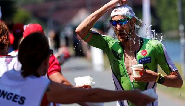 An athlete tries to cool down as he competes in the Ironman triathlon European Championships in Frankfurt, Germany
