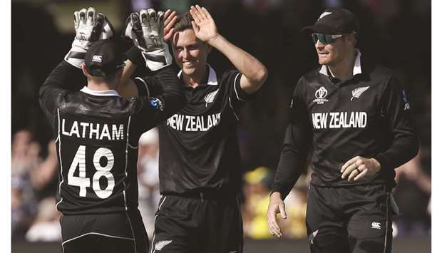 New Zealandu2019s Trent Boult (centre) celebrates with teammates after taking the wicket of Australiau2019s Jason Behrendorff during the 2019 ICC Cricket World Cup match against Australia at Lordu2019s Cricket Ground in London on Saturday. (AFP)