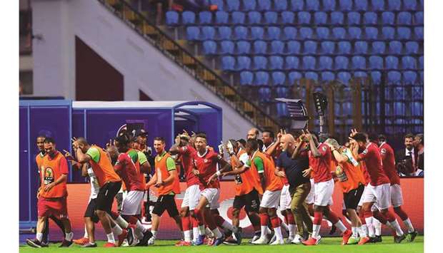 Madagascaru2019s players celebrate after their win over Nigeria in the Africa Cup of Nations Group B match at the Alexandria Stadium yesterday. (AFP)