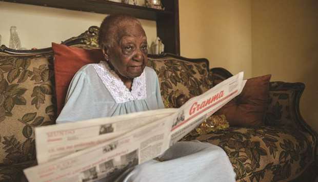 Rigoberta Santovenia, 102, reads a newspaper at her house in Havana.