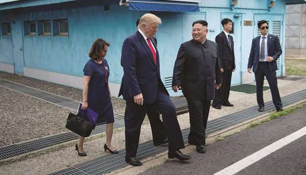 North Koreau2019s leader Kim Jong-un and US President Donald Trump walk together south of the Military Demarcation Line that divides North and South Koreas, after Trump briefly stepped over to the northern side, in the Joint Security Area (JSA) of Panmunjom in the demilitarised zone (DMZ) yesterday.