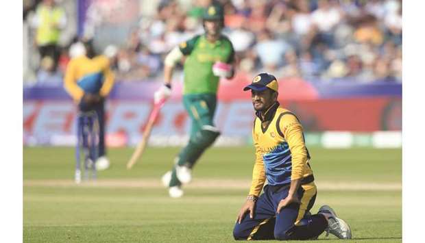 Sri Lankau2019s captain Dimuth Karunaratne (right) reacts to a misfield during the 2019 ICC Cricket World Cup match against South Africa at the Riverside Ground in Chester-le-Street, United Kingdom, on Friday. (AFP)