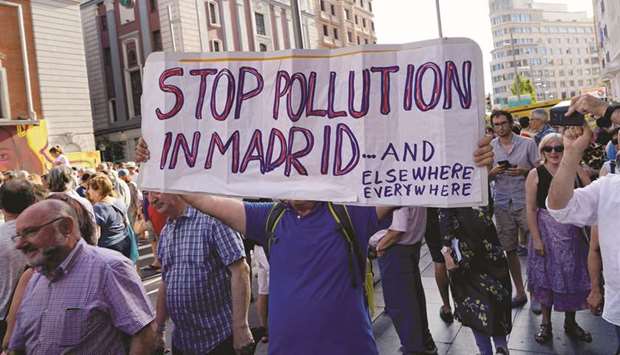 Demonstrators take part in a protest against Madridu2019s new conservative Popular Party (PP) municipal governmentu2019s plans to suspend some anti-car emissions policies in the city centre.