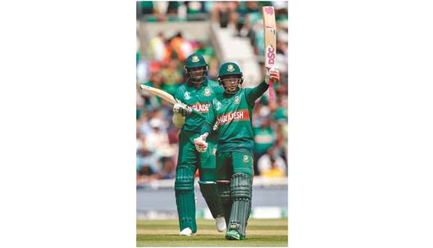 Bangladeshu2019s Mushfiqur Rahim (right) acknowledges the crowd after reaching a half-century (50 runs) as teammate Shakib Al Hasan looks on during the 2019 Cricket World Cup match against South Africa at The Oval in London yesterday. (AFP)