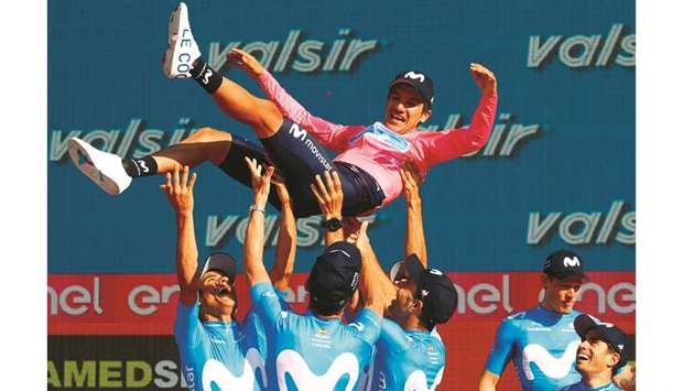 Team Movistar rider Ecuadoru2019s Richard Carapaz is thrown in the air by his teammates as they celebrate on the podium after the final stage of the 102nd Giro du2019Italia in Verona yesterday.