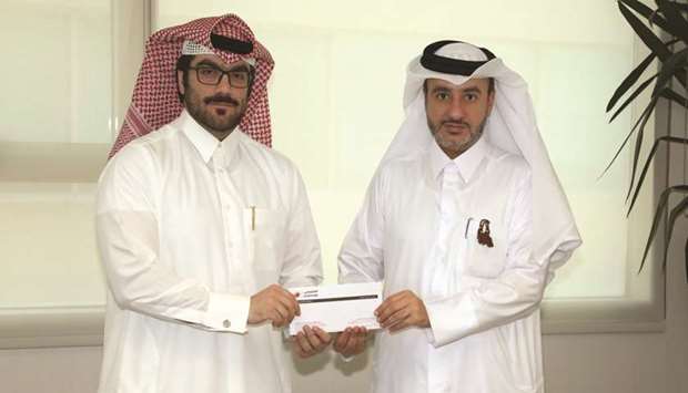 Al Khaliji and QCS officials at the cheque presentation ceremony.