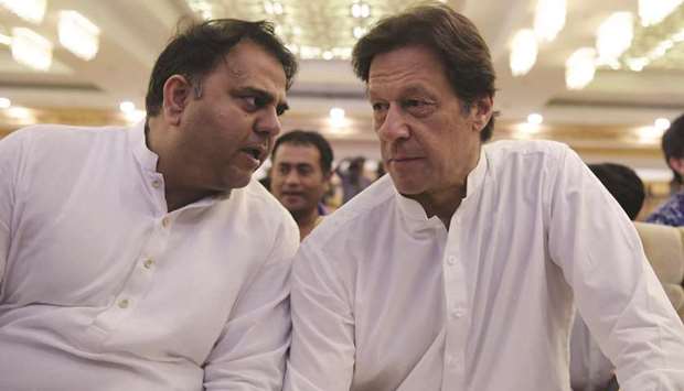 This file picture shows Chaudhry with Prime Minister Khan. Chaudhry was removed as information minister and given the science and technology ministry in a cabinet reshuffle in April.