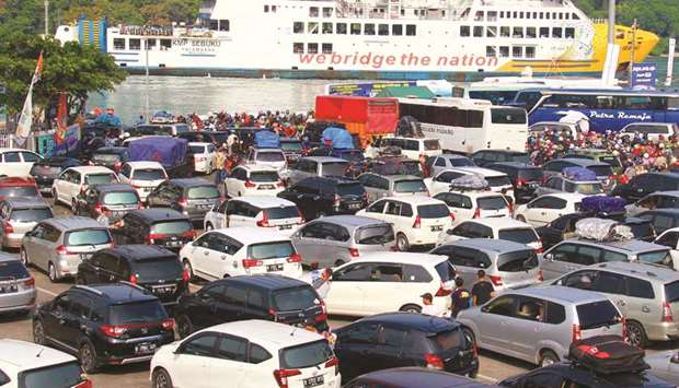 Vehicles queue to enter in a ferry to go to Sumatra at the Merak port in Cilegon, Banten province, yesterday.
