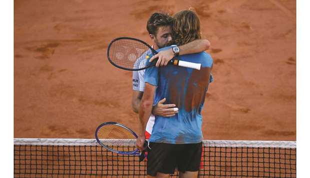 Switzerlandu2019s Stanislas Wawrinka (L) hugs Greeceu2019s Stefanos Tsitsipas at the end of their fourth round match on day eight of French Open in Paris yesterday.
