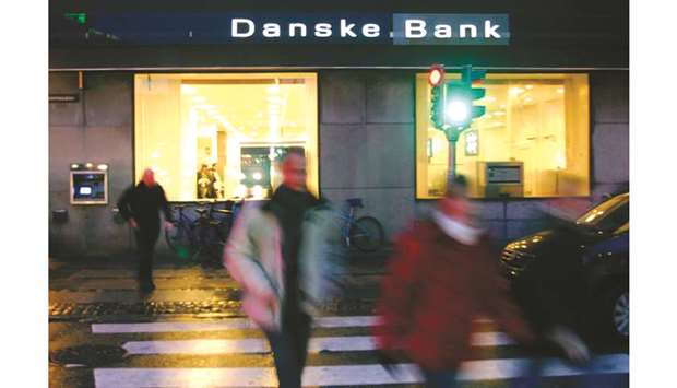 Residents walk past a Danske Bank branch in Copenhagen. Danske is being investigated in the US and across Europe amid signs it became a conduit for dirty Russian money.