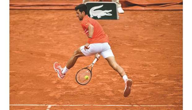 Serbiau2019s Novak Djokovic returns the ball to Germanyu2019s Jan-Lennard Struff during their fourth round match at the French Open in Paris  yesterday.