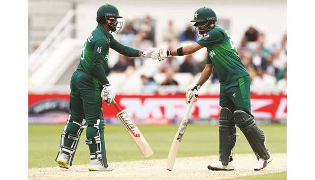 Pakistanu2019s Mohamed Hafeez (L) and Babar Azam bump gloves during their World Cup match against England at Trent Bridge yesterday.