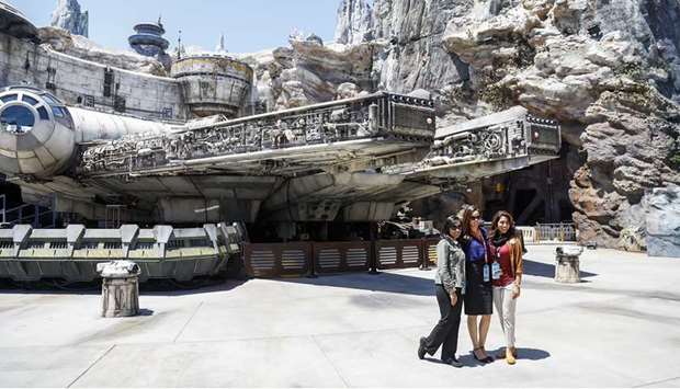 GREET: Cast members greet people at the start of The Millennium Falcon: Smugglers Run ride.