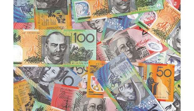 Australian dollar banknotes of various denominations are arranged for a photograph in Sydney. The Australian dollar will continue to fall as the nationu2019s central bank cuts interest rates further to stimulate the faltering economy, according to market participants.