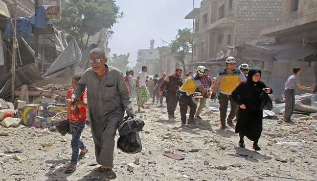 Members of the Syrian Civil Defence carry a wounded man on a stretcher following a reported air strike on the town of Maaret al-Numan in the militant-held Idlib province, yesterday.