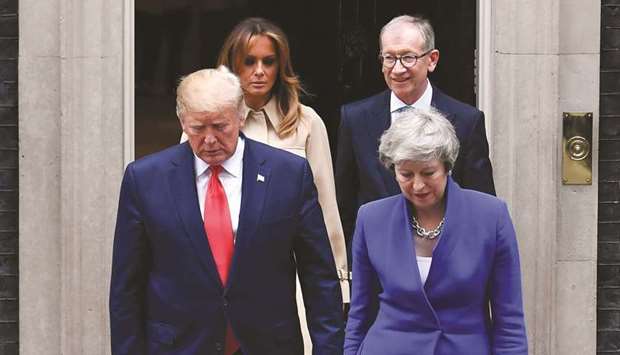 Prime Minister Theresa May and US President Donald Trump, are followed by her husband Philip May and US First Lady Melania Trump as they leave 10 Downing Street to make their way to the Foreign and Commonwealth Office for a press conference in London yesterday.
