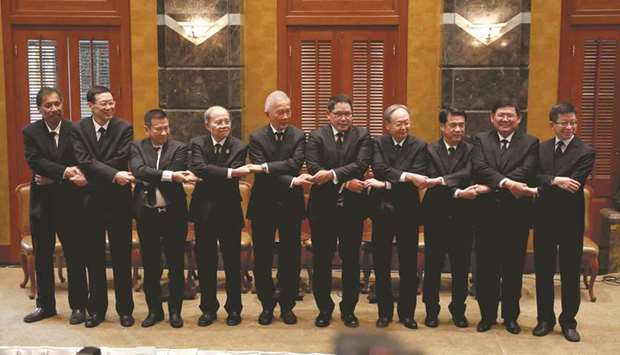Various party leaders pose for photo after a press conference led by the Palang Pracharat Party in Bangkok yesterday.
