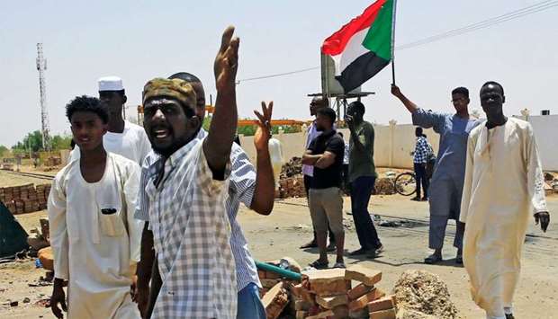 Sudanese protesters set up a barricade on a street, demanding that the country's Transitional Military Council hand over power to civilians, in Khartoum