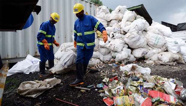 Nepali workers drag sacks of waste collected from Mount Everest for recycling, in Kathmandu