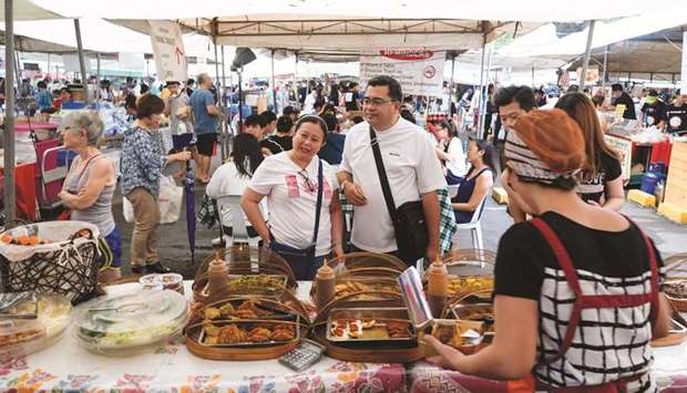 Customers browse food displayed at a stall in the Legazpi Sunday Market in the Makati district of Manila. Consumer price index in Philippines in May rose 3.2% from a year earlier due to a rise in food and utility prices, the statistics agency said yesterday.
