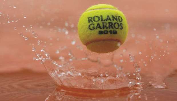 A 2019 French Open tennis tournament official ball bounces on a cover as rain falls on day eleven of The Roland Garros 2019 French Open tennis tournament in Paris yesterday. (AFP)