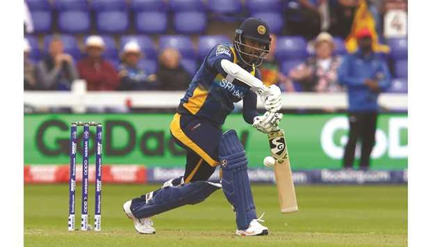 Sri Lankau2019s captain Dimuth Karunaratne plays a shot during the 2019 ICC Cricket World Cup match against Afghanistan at Sophia Gardens stadium in Cardiff, Wales, on Tuesday. (AFP)