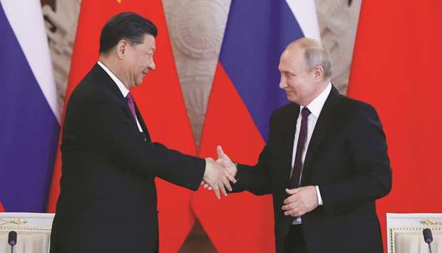 Xi and Putin shake hands after a signing ceremony following their talks at the Kremlin.