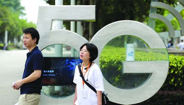 Employees wait for a shuttle bus at a 5G testing park at Huawei's headquarters in Shenzhen.