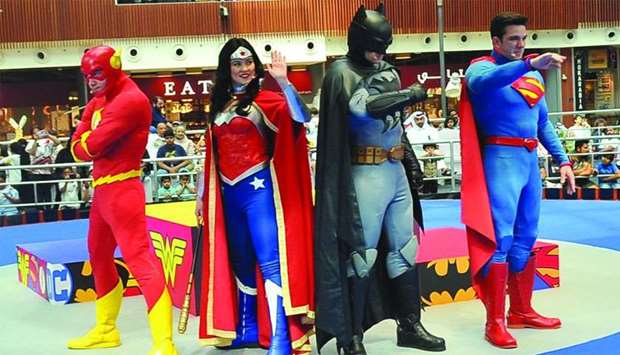 (From left) The Flash, Wonder Woman, Batman, and Superman wave to young fans during a live show at the Mall of Qatar's Ooredoo Stage on Thursday. PICTURES: Nasar K Moidheen.
