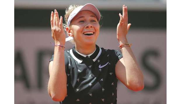 Amanda Anisimova celebrates after defeating Simona Halep in French Open quarter-final yesterday. (Reuters)