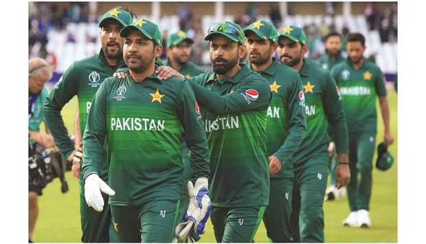 Pakistan captain Sarfaraz Ahmed (second from left) leads his team off of the pitch after winning the 2019 ICC Cricket World Cup match against England at Trent Bridge in Nottingham, England, on Monday. (AFP)