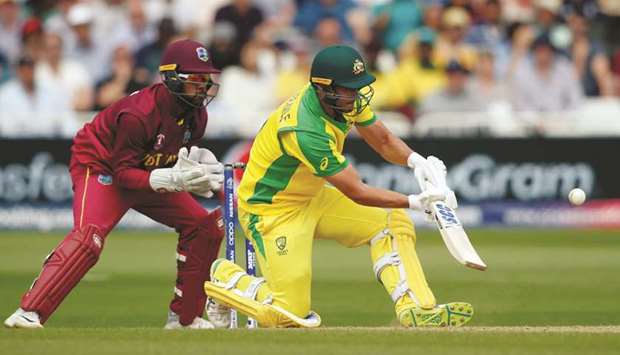 Australiau2019s Nathan Coulter-Nile (right) hits a boundary during the 2019 ICC Cricket World Cup match against West Indies at Trent Bridge in Nottingham, Britain, yesterday. (Reuters)