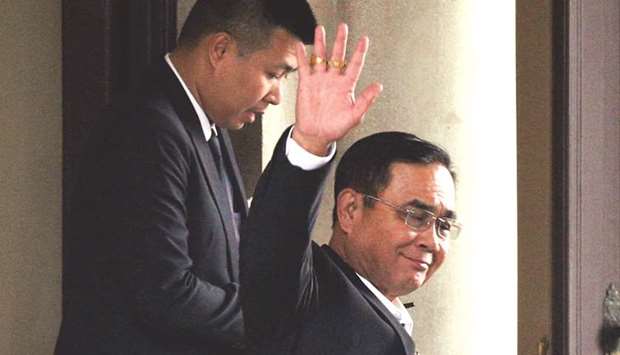 Thailandu2019s Prime Minister Prayuth Chan-o-Cha waves as he leaves at the Government House in Bangkok, Thailand, yesterday.