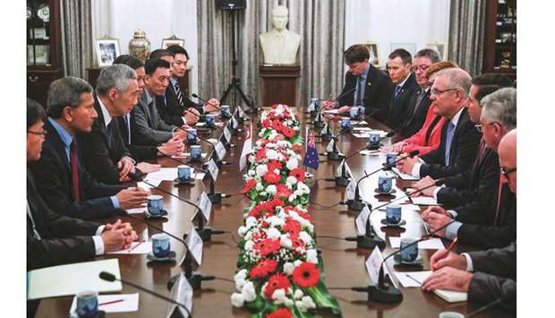 Singaporeu2019s Prime Minister Lee Hsien Loong (3rd left) and Australiau2019s Prime Minister Scott Morrison (4th right) attend a bilateral meeting at the Istana Presidential Palace in Singapore. Trade tensions and high-tech rivalry between the US and China are having a u201cvery negative influenceu201d on the world economy, Morrison said yesterday.