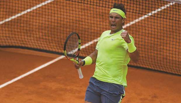Spainu2019s Rafael Nadal reacts after winning a point against Switzerlandu2019s Roger Federer during their menu2019s singles French Open semi-final at Roland Garros in Paris yesterday. (AFP)