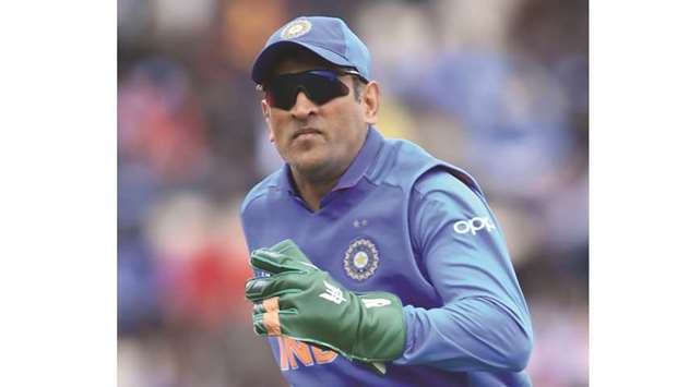 Indiau2019s MS Dhoni sports a dagger logo on his green wicket-keeping gloves during the match against South Africa in Southampton on Wednesday. (AFP)
