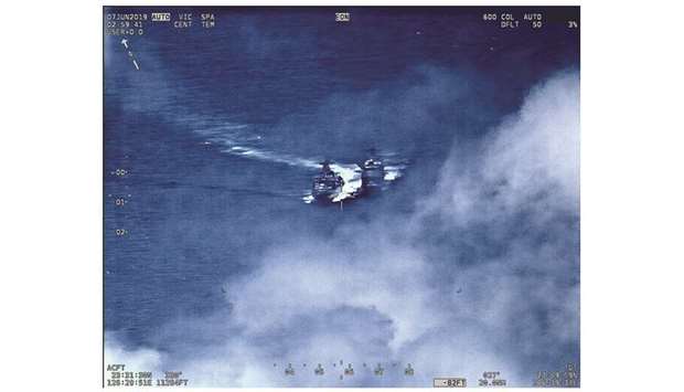 This image released by the US Navy shows the Russian anti-submarine ship Admiral Vinogradov (left) sailing close to the USS Chancellorsville.