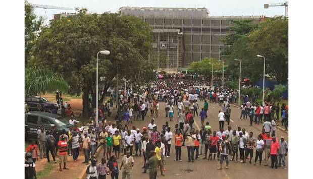 Demonstrators gather outside the Liberian Mansion in Monrovia, yesterday, during an anti-government march to protest over inflation and corruption.
