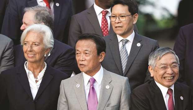 Japanu2019s Finance Minister Taro Aso stands next to IMF managing director Christine Lagarde and Bank of Japan governor Haruhiko Kuroda during the G20 finance ministers and central bank governors meeting in Fukuoka, Japan. Kuroda said while global growth was expected to rebound at the latter half of this year, trade tensions were making the outlook uncertain.
