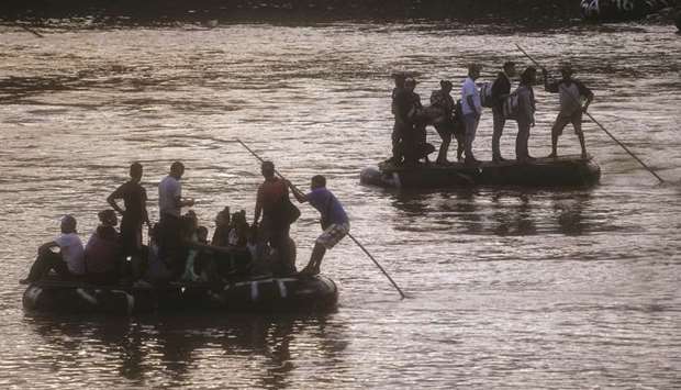 Migrants and locals use a makeshift raft to illegally cross the Suchiate river, from Tecun Uman, in Guatemala to Ciudad Hidalgo, Chiapas state, Mexico.