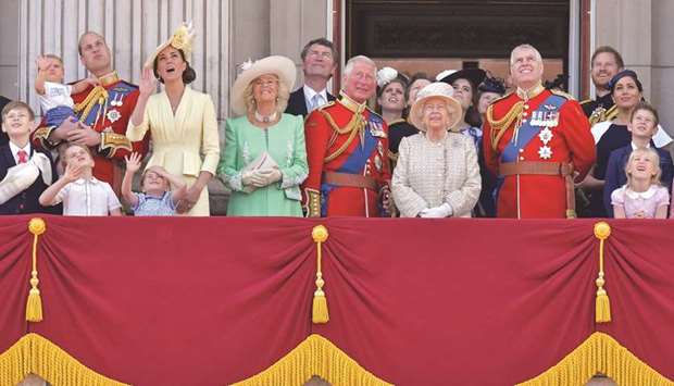 (From left) Prince William, Duke of Cambridge, holding Prince Louis, Prince George, Princess Charlotte, Catherine, Duchess of Cambridge, Camilla, Duchess of Cornwall, Vice Admiral Timothy Laurence, Prince Charles, Prince of Wales, Princess Beatrice of York, Princess Anne, Princess Royal, Queen Elizabeth II, Princess Eugenie of York, Lady Louise Windsor, Prince Andrew, Duke of York, Prince Harry, Duke of Sussex, Meghan, Duchess of Sussex, James, Viscount Severn and Isla Phillips stand with other members of the royal family on the balcony of Buckingham Palace to watch a fly-past of aircraft by the Royal Air Force in London yesterday.