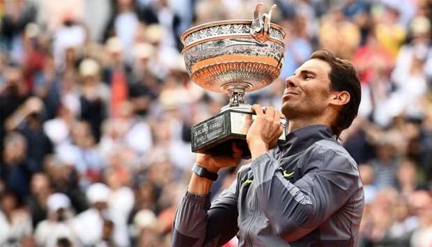 Spain's Rafael Nadal poses with the Mousquetaires Cup (The Musketeers) at the end of the men's singles final match against Austria's Dominic Thiem on day fifteen of The Roland Garros 2019 French Open tennis tournament in Paris