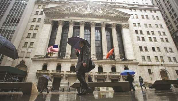 Pedestrians walk past the New York Stock Exchange (file). The S&P 500 remains within striking distance from its all-time high in its longest-ever bull market, but the gauge has slumped during recent slowdowns.