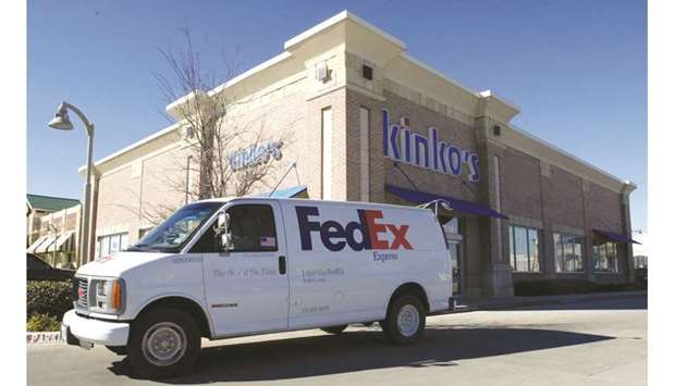 A FedEx delivery truck is driven past a Kinkou2019s copy centre in Frisco, Texas. The Amazon contract with the Express air division expires at the end of this month, and doesnu2019t cover international operations or other services such as FedExu2019s ground deliveries.