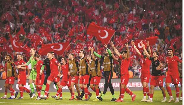 Turkey players celebrate after their win over France in the Euro 2020 qualification match at the Buyuksehir Belediyesi stadium in Konya, Turkey, on Saturday night. (AFP)