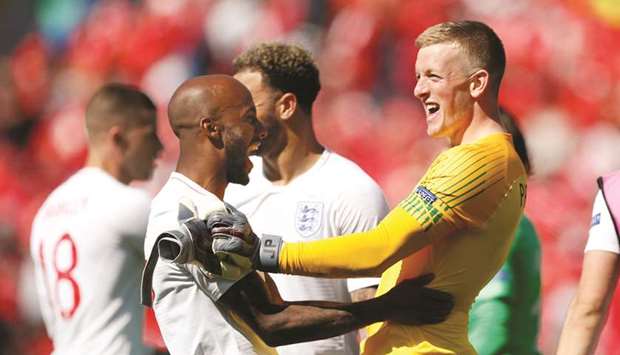 Englandu2019s Jordan Pickford (right) celebrates with Fabian Delph after winning the  Nations League third-place play off match against Switzerland. (Reuters)