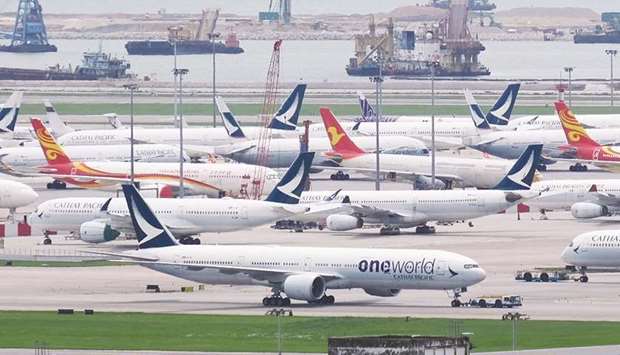 Aircraft operated by Cathay Pacific Airways and its Cathay Dragon unit stand on the tarmac at the Hong Kong International Airport. Cathay has grounded most of its planes, flying only cargo and a skeleton passenger network to major destinations such as Beijing, Los Angeles, Sydney and Tokyo.