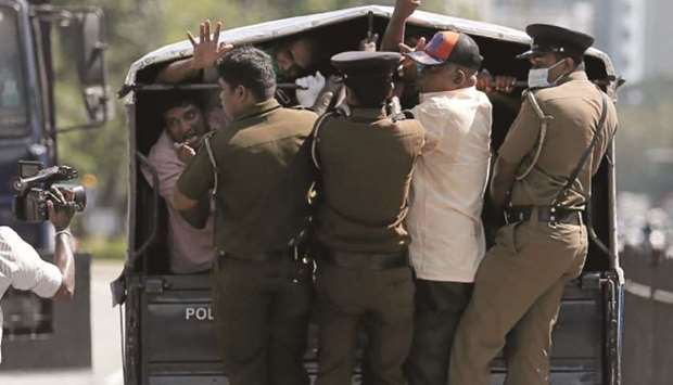 Members of the Frontline Socialist Party react at police officers who detained them on their way to a protest against the death in Minneapolis police custody of George Floyd, in front of the US embassy in Colombo yesterday.